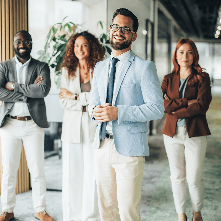 Smiling professionals posing in modern office.
