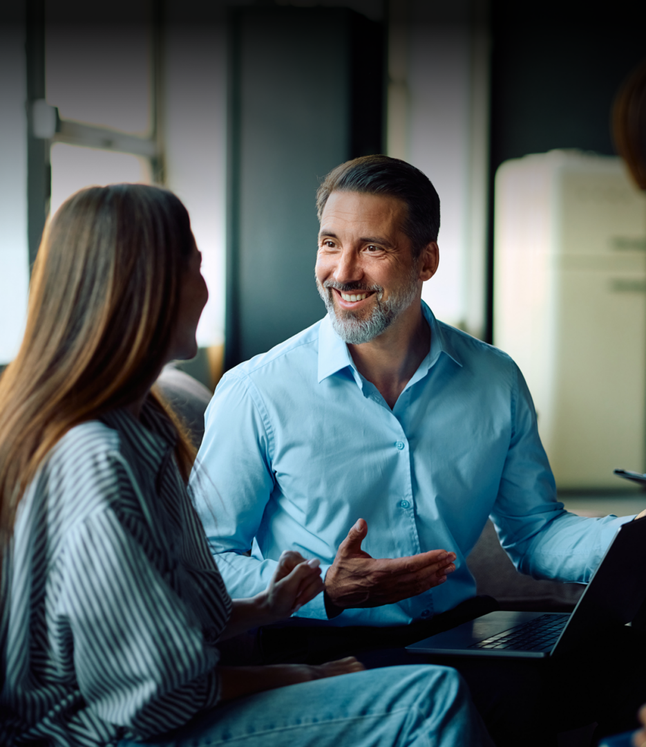 Man and woman talking by laptop